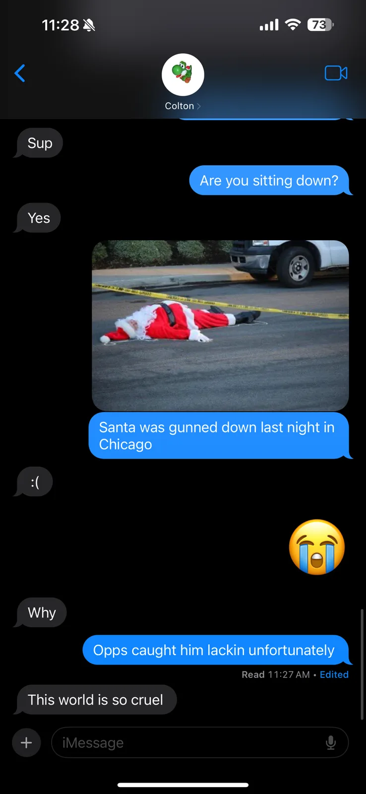 A screenshot of a text conversation shows a person sending a photo of a man dressed as Santa Claus lying on the pavement…