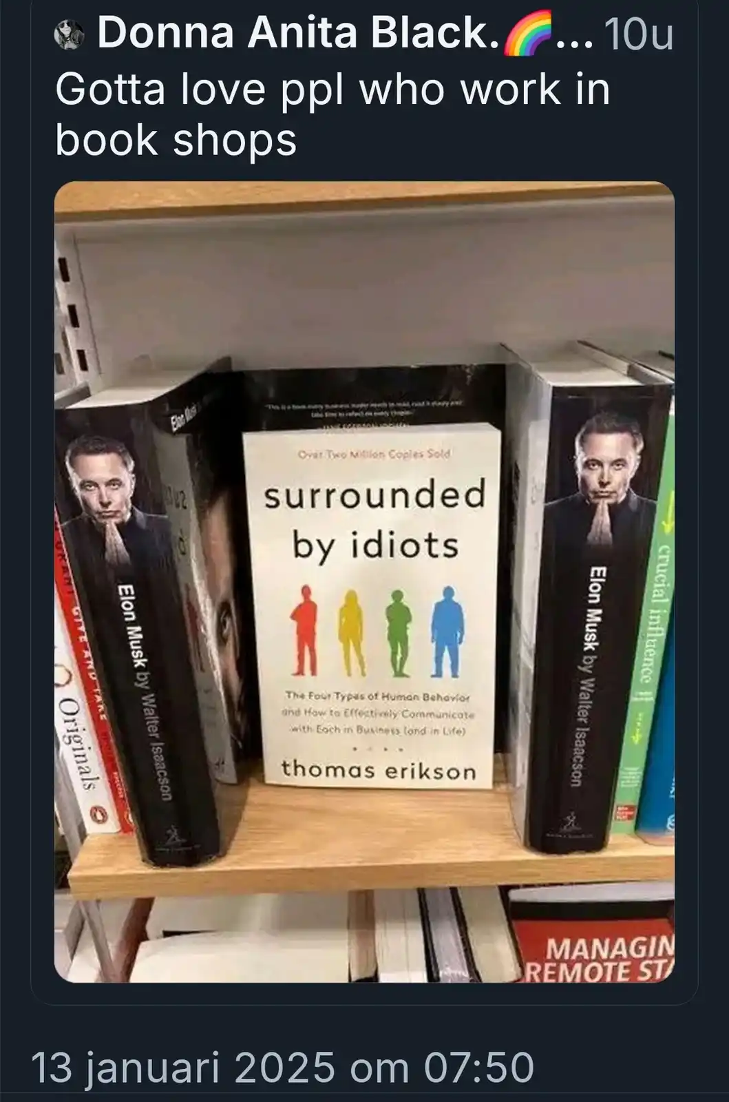 A bookshelf displays a book titled 'surrounded by idiots' by Thomas Erikson, flanked by two copies of 'Elon Musk by Walter…