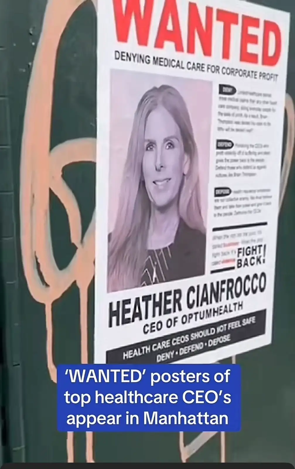 A 'WANTED' poster featuring a photo of Heather Cianfrocco, CEO of OptumHealth, is displayed on a wall. The poster accuses…