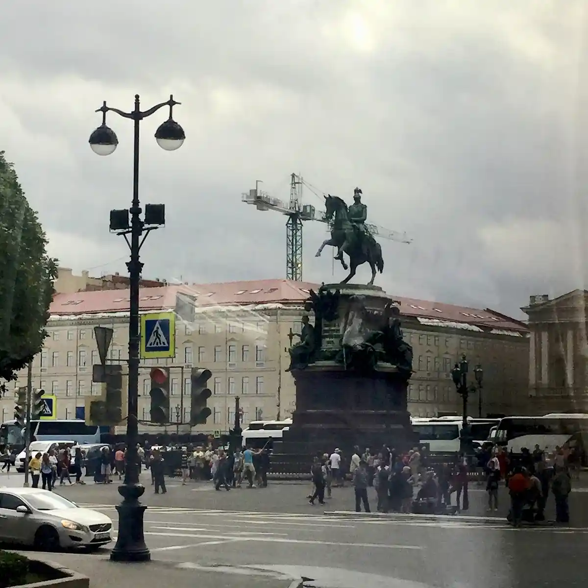 A photo of a large equestrian statue in a city square with people and traffic around it, overlaid with the text 'i'm not a…