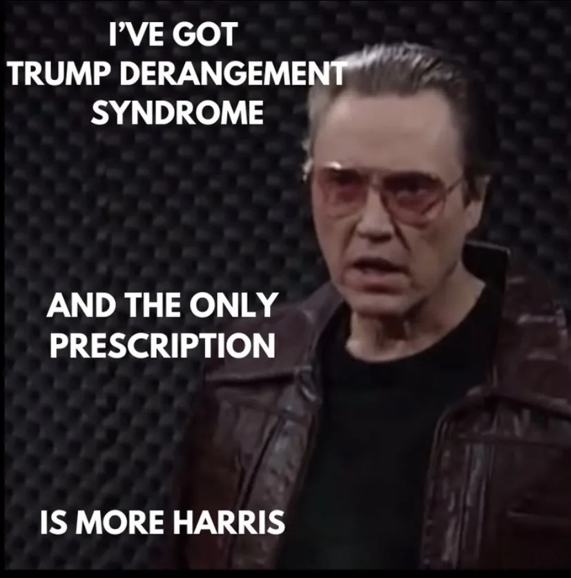 A man with slicked-back hair, wearing red-tinted glasses and a brown leather jacket, looks intensely at the camera against a…