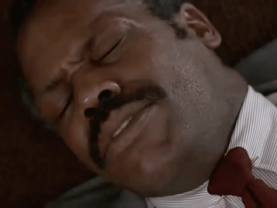 A four-panel meme featuring a man with a mustache, wearing a white shirt and red tie, lying down with his eyes closed and a…