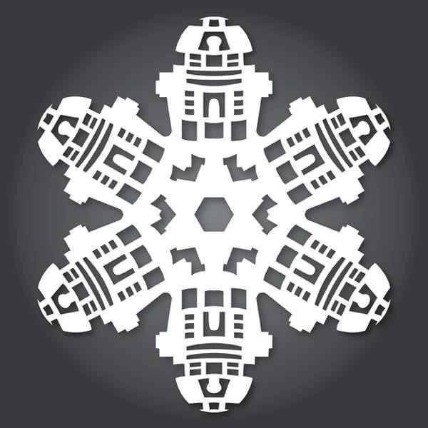 A white paper-cutout snowflake with six arms, each shaped like the head and upper torso of the Star Wars droid R2-D2…
