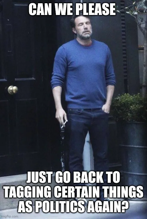 A man in a blue sweater stands outside a dark door with his eyes closed and head tilted back, looking exhausted. The…