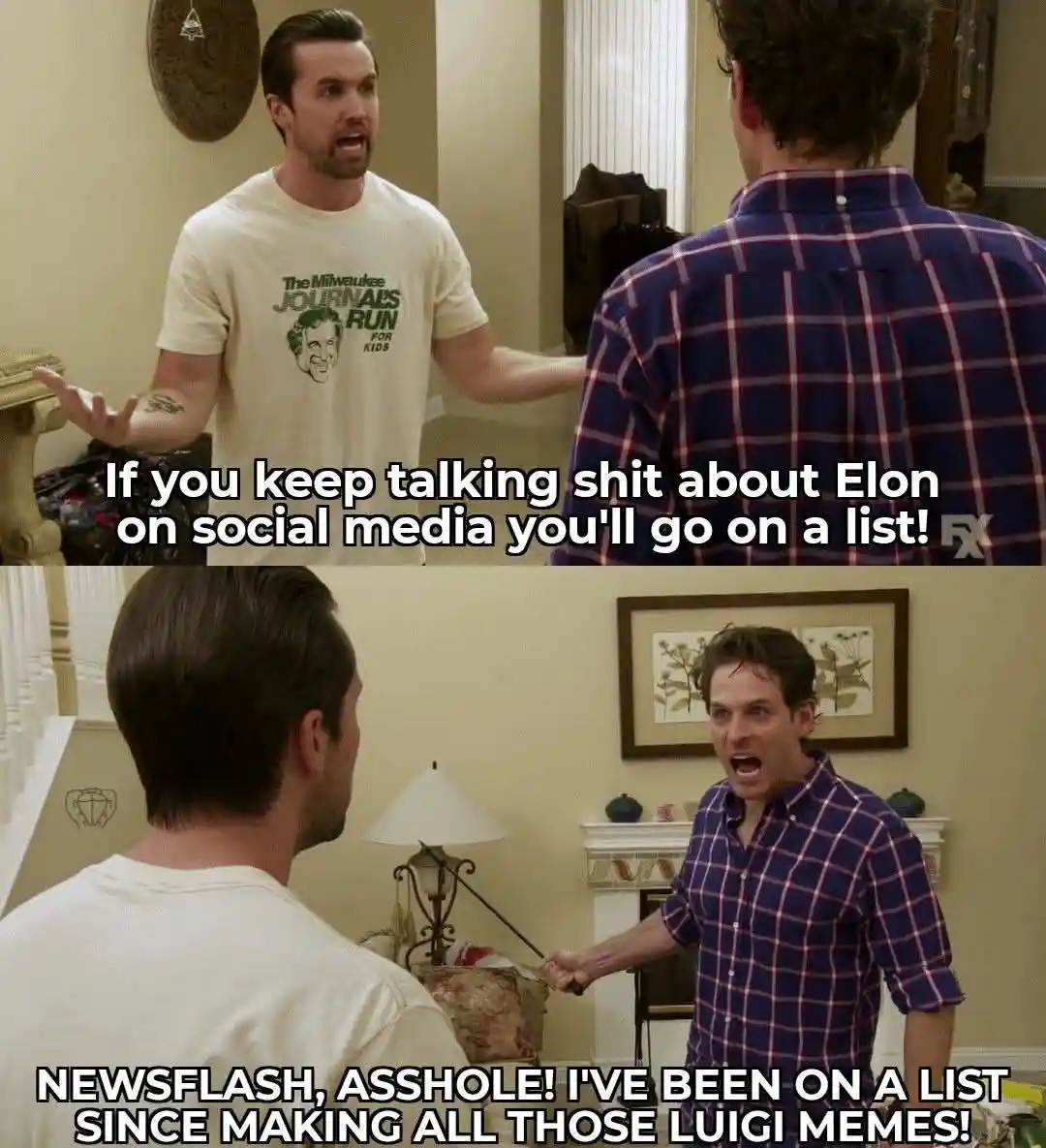 Two men are in a heated argument in a living room. The man in the white t-shirt, facing the camera, shouts at the other man…
