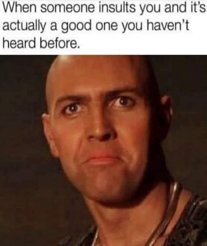A close-up image of a bald man with a confused and slightly impressed facial expression, looking upward and to his right…