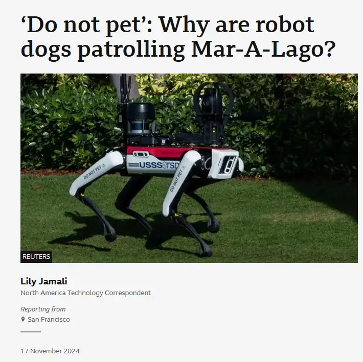 A robotic dog with 'DO NOT PET' written on its legs and 'USSS/TSD' on its torso stands on green grass in front of bushes…