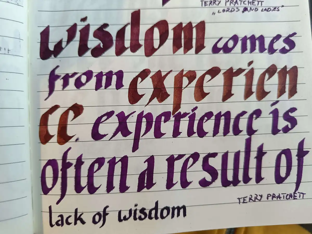 A handwritten quote in purple and black ink on lined notebook paper reads: 'wisdom comes from experience (c. experience is…