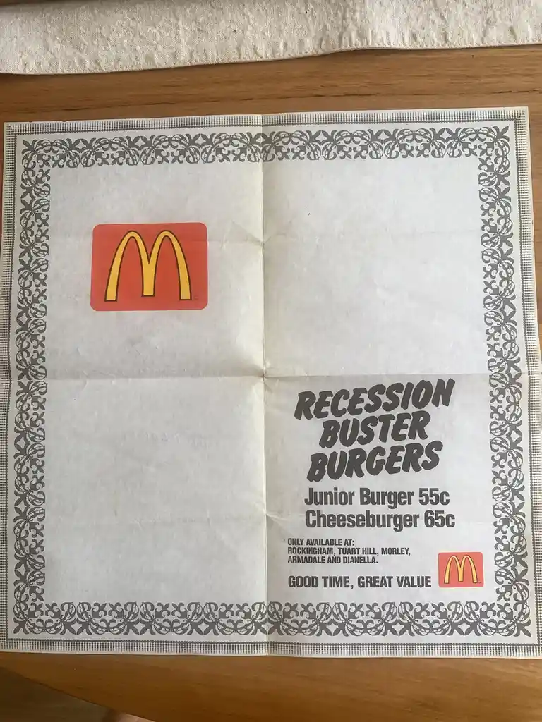 A vintage McDonald's promotional flyer with ornate grey borders, featuring the McDonald's logo and text advertising…