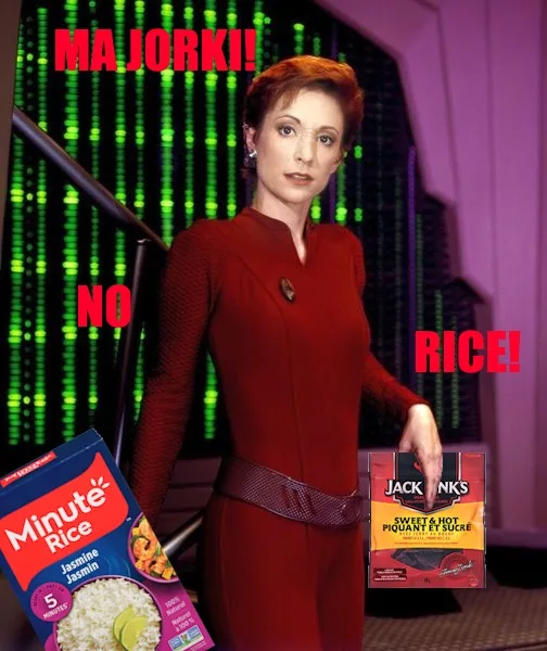 A woman in a red Star Trek uniform stands in front of a green digital matrix background, holding a box of Jack Link's Sweet…