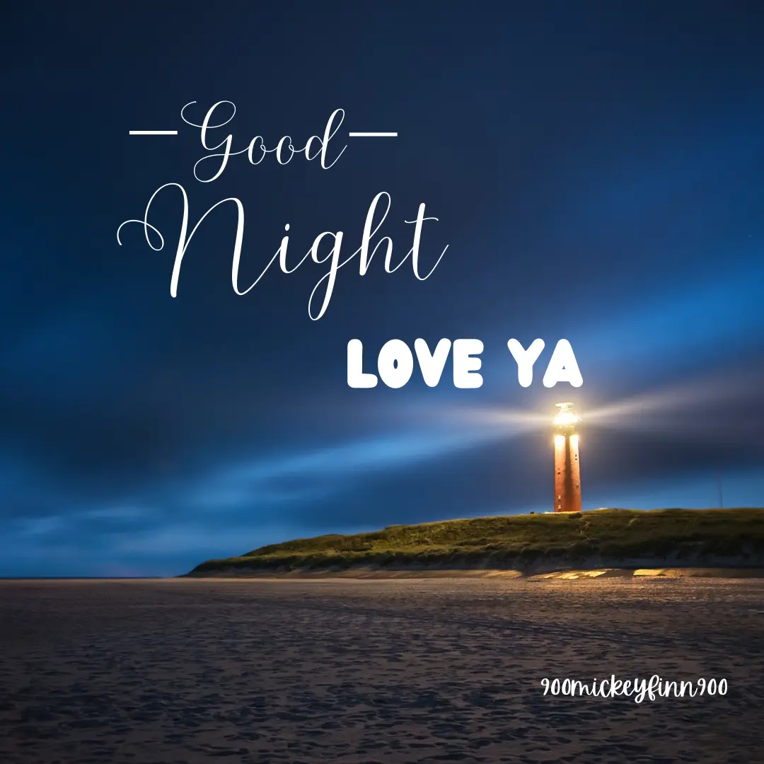 A serene night scene featuring a lighthouse on a grassy headland overlooking a calm beach under a deep blue sky. White…