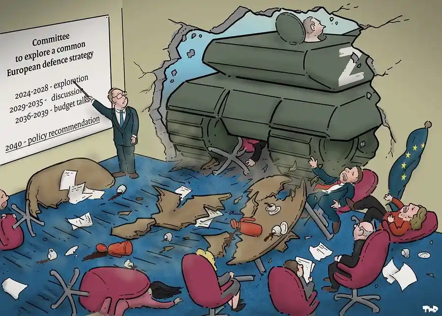 A cartoon depicts a large green tank with a 'Z' emblem breaking through a wall into a meeting room, crushing people and…
