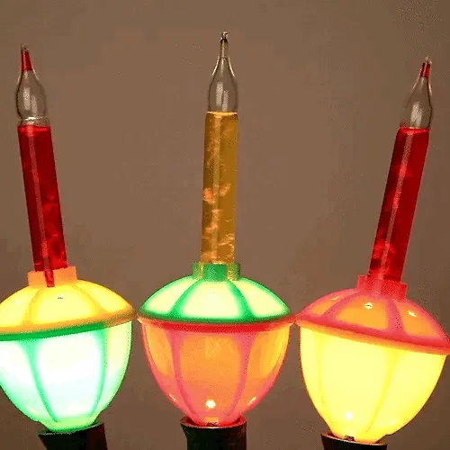 A grid of 16 identical vintage-style Christmas lights, each with a glowing bulb and a red and yellow liquid-filled stem…