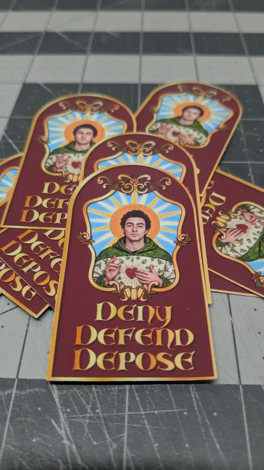 Several stickers feature a man with curly hair wearing a green robe and holding a glowing red heart, set against a blue and…