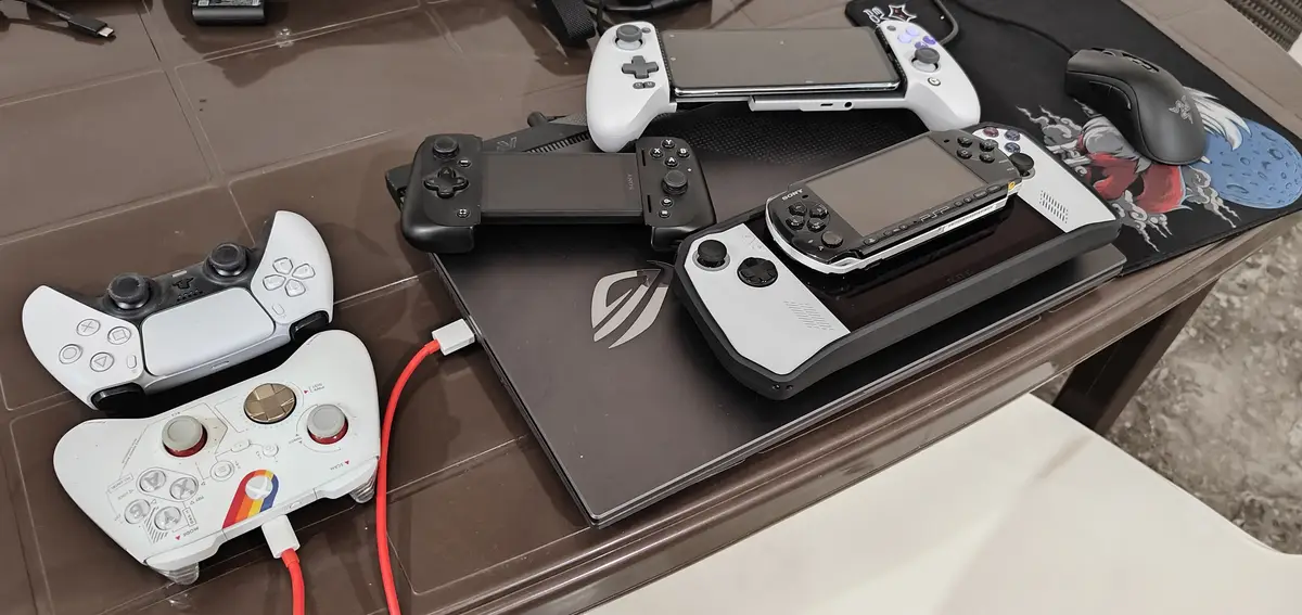 A collection of gaming peripherals including a PS5 controller, PS4 controller, Xbox controller, a PSP handheld, and a…