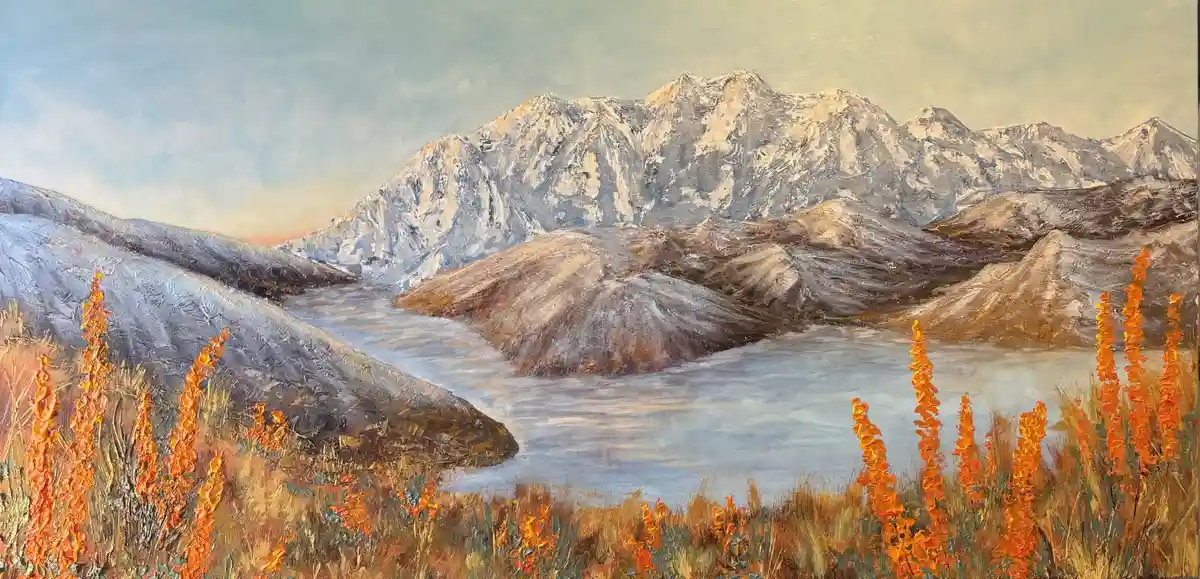 A painting of a serene mountain landscape with snow-capped peaks, a calm lake, and vibrant orange wildflowers in the…