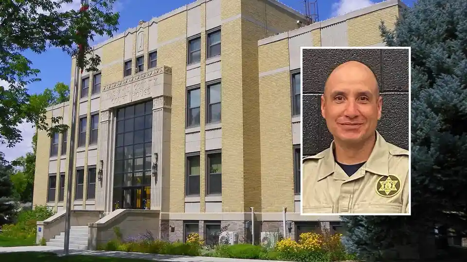 An image of the Washtee County Courthouse with a photo of a bald man in a sheriff's uniform superimposed on the right side…