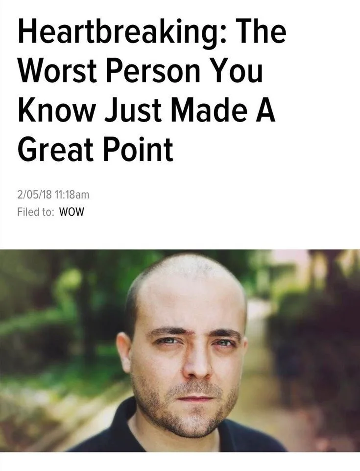 The image displays a man with a bald head and light stubble, looking directly at the camera with a neutral expression. Above…