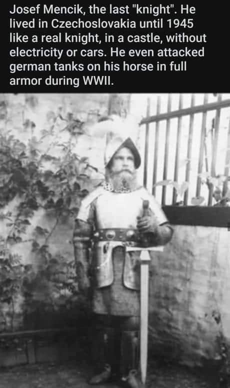 A black-and-white photograph shows a man in full medieval knight armor, including a helmet with a plume, chainmail, and a…