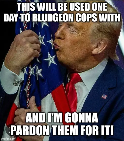 A close-up photo of Donald Trump kissing an American flag while wearing a suit and red tie. White bold text is overlaid in…