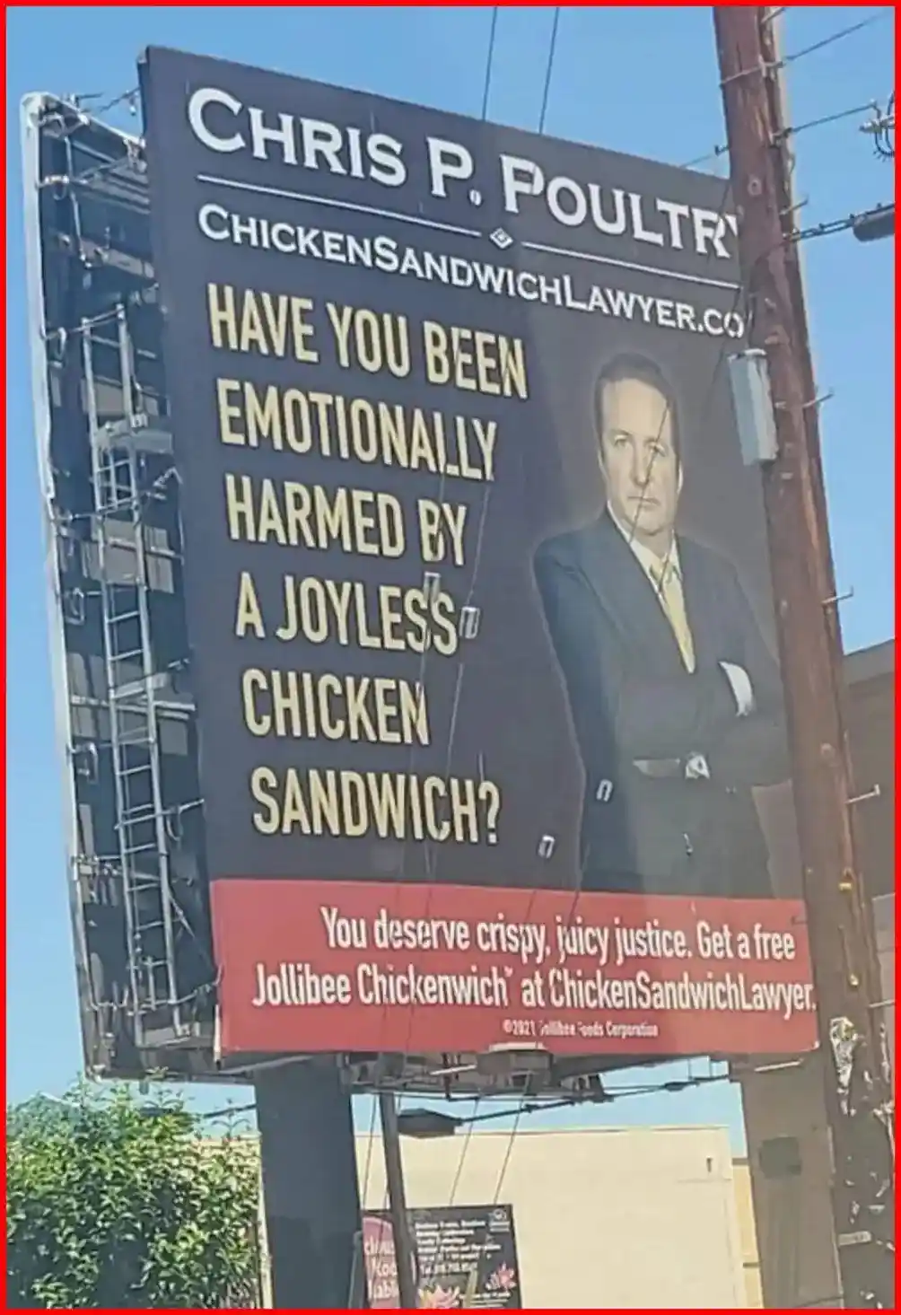 A large billboard features a man in a suit with the text 'CHRIS P. POULTRY' and 'CHICKEN SANDWICH LAWYER.CO'. The main…