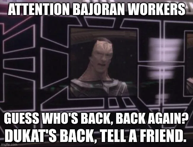 A still image of the character Dukat from Star Trek: Deep Space Nine, shown in a futuristic control room interface. The…