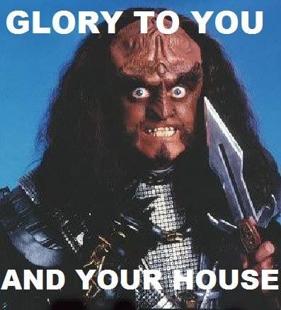 A close-up image of a menacing, horned, demonic-looking character with long dark hair, wide eyes, and a grimacing…