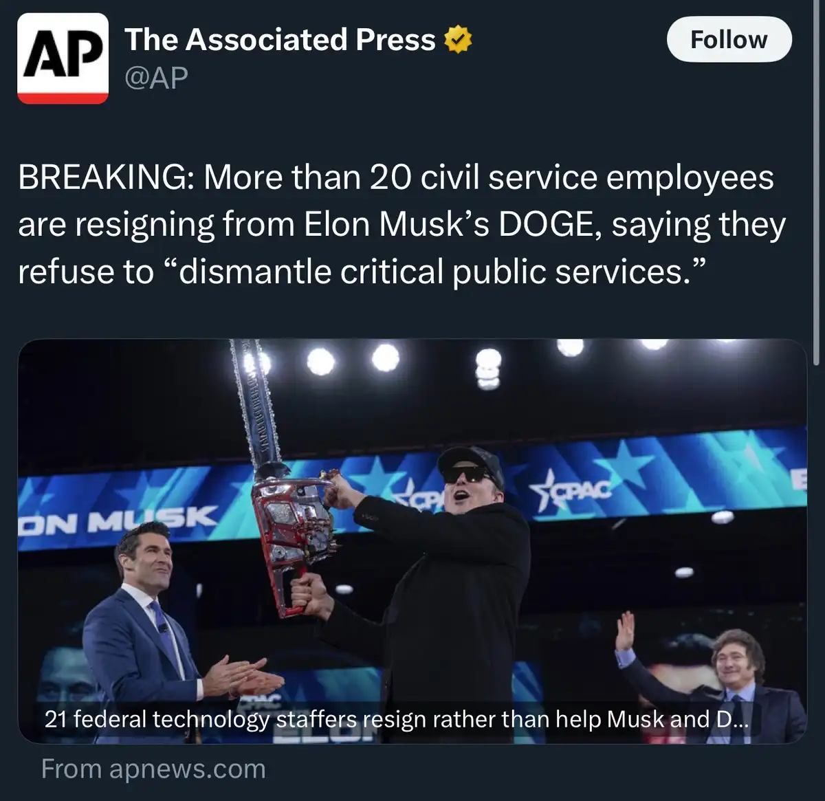 A screenshot of a tweet from The Associated Press shows a photo of Elon Musk holding a chainsaw-themed trophy on stage at…