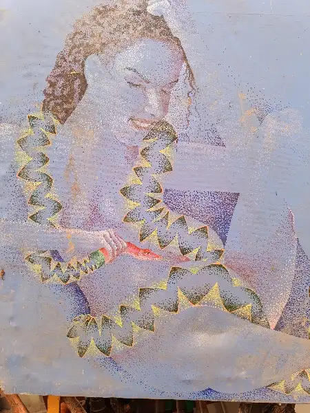 A person with curly hair is shown in a stylized, dotted art style, holding a paintbrush and looking at a painting that…