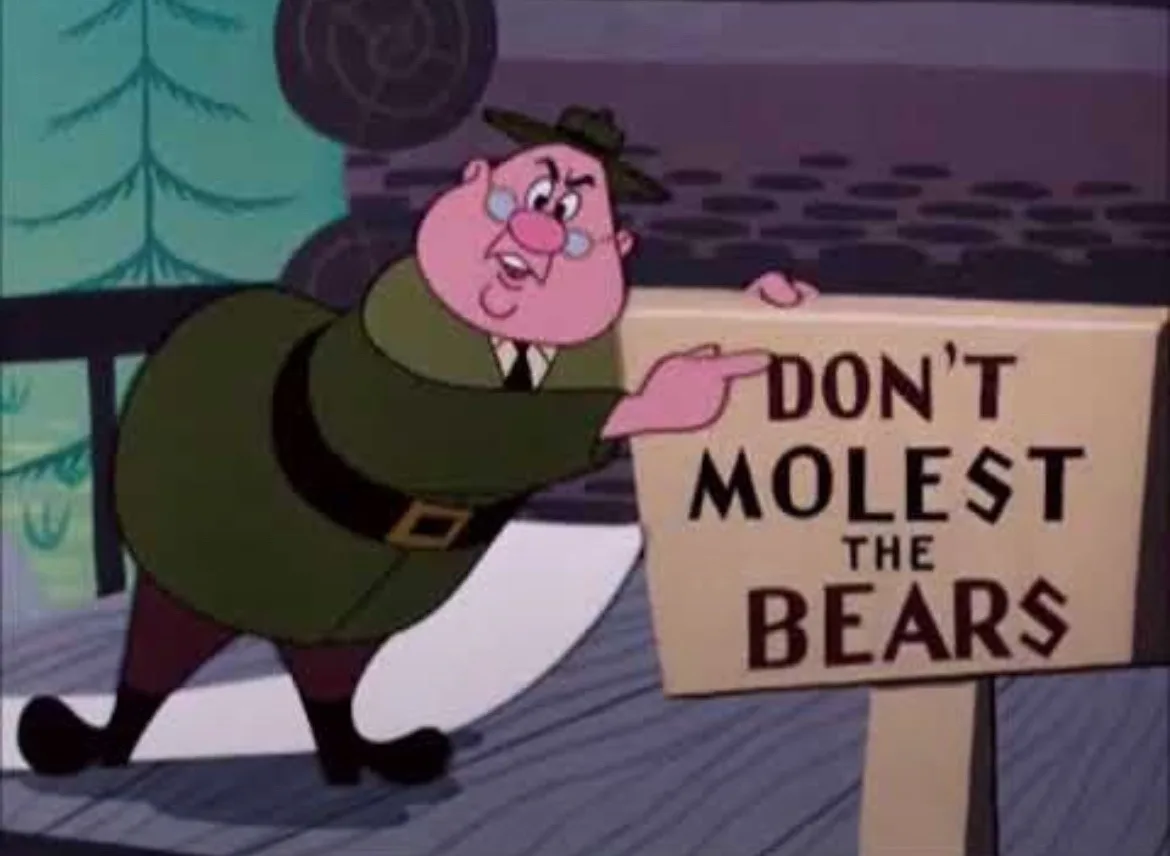 A cartoon park ranger in a green uniform and hat points emphatically at a wooden sign that reads 'DON'T MOLEST THE BEARS'…