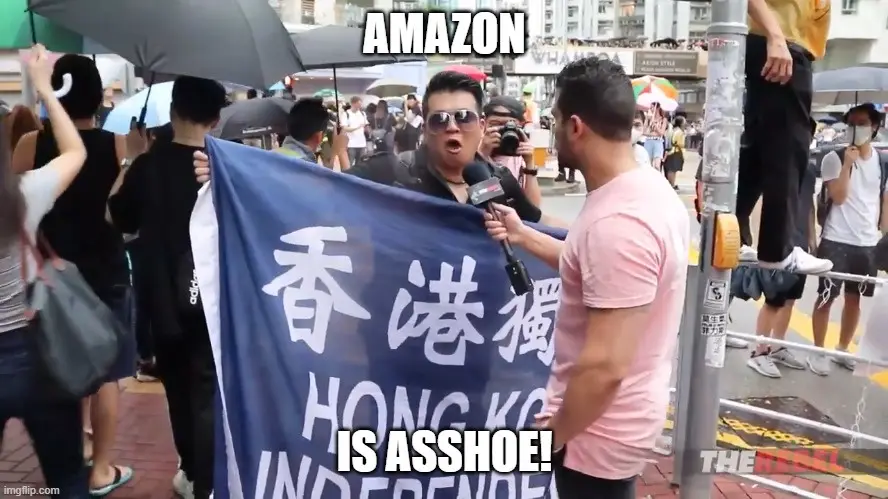 A man wearing sunglasses holds a blue banner with Chinese characters and the English text 'HONG KONG INDEPENDENCE' while…