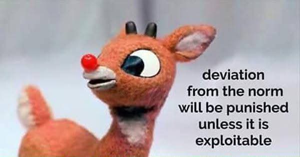 A plush toy of Rudolph the Red-Nosed Reindeer with a large, expressive eye and his signature red nose, looking slightly to…