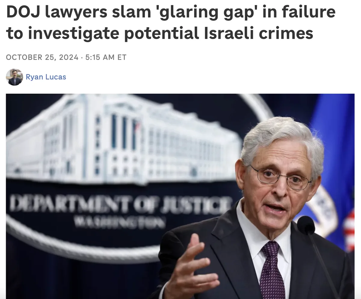 A man in a suit and glasses speaks at a podium in front of a blurred Department of Justice backdrop. The overlaid text reads…