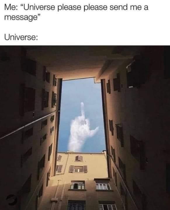 A low-angle photo looking up between two buildings at a cloud shaped like a hand giving the middle finger. Text above reads…