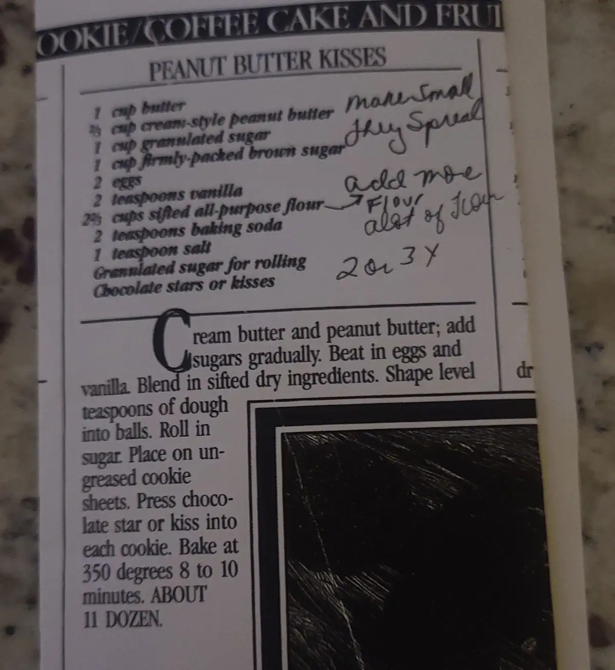 A printed recipe for 'Peanut Butter Kisses' cookies shows handwritten notes scribbled next to ingredients, including 'more…