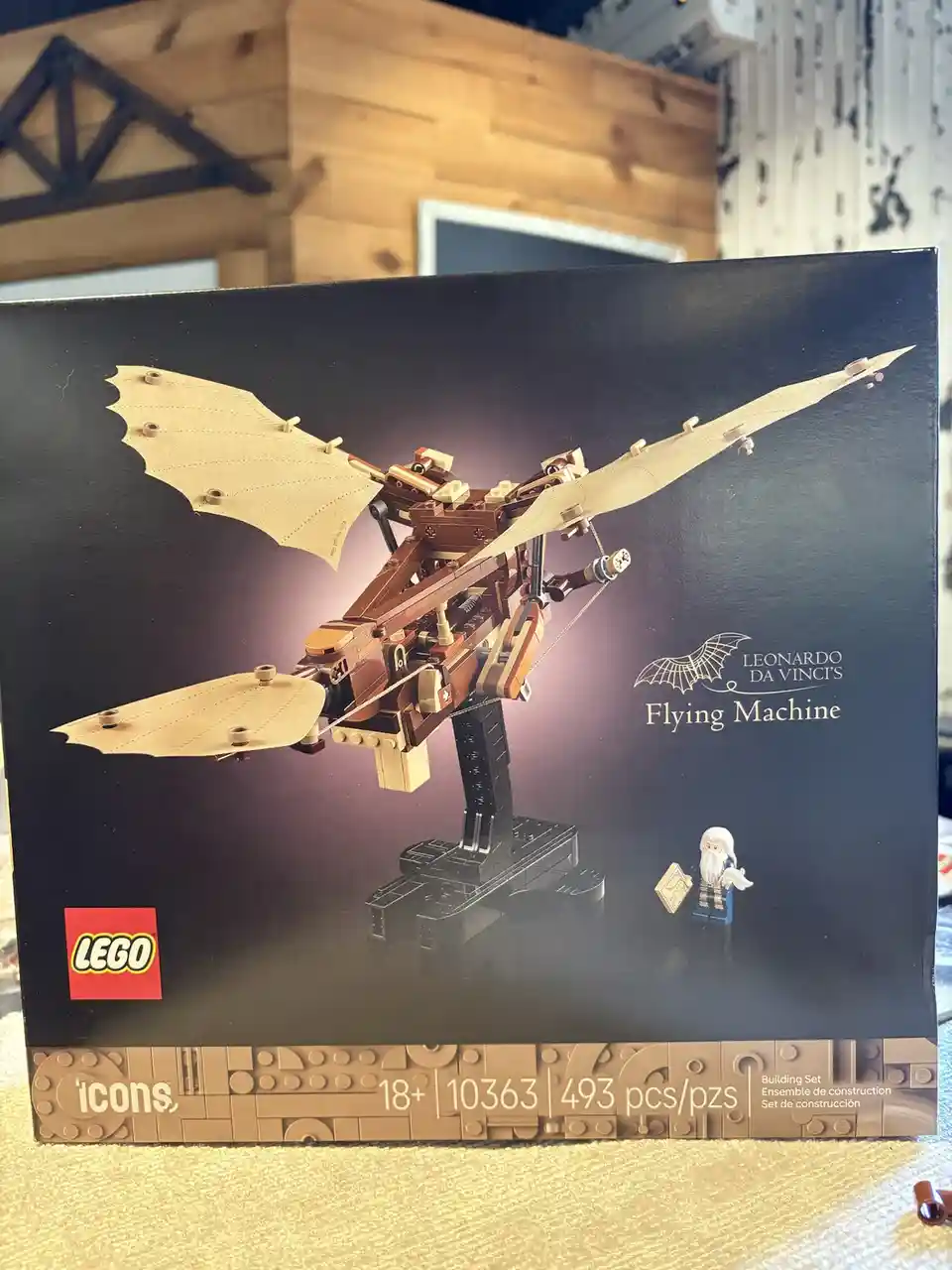 A photo of a LEGO Icons set box for 'Leonardo da Vinci's Flying Machine', showing the assembled model with tan fabric wings…