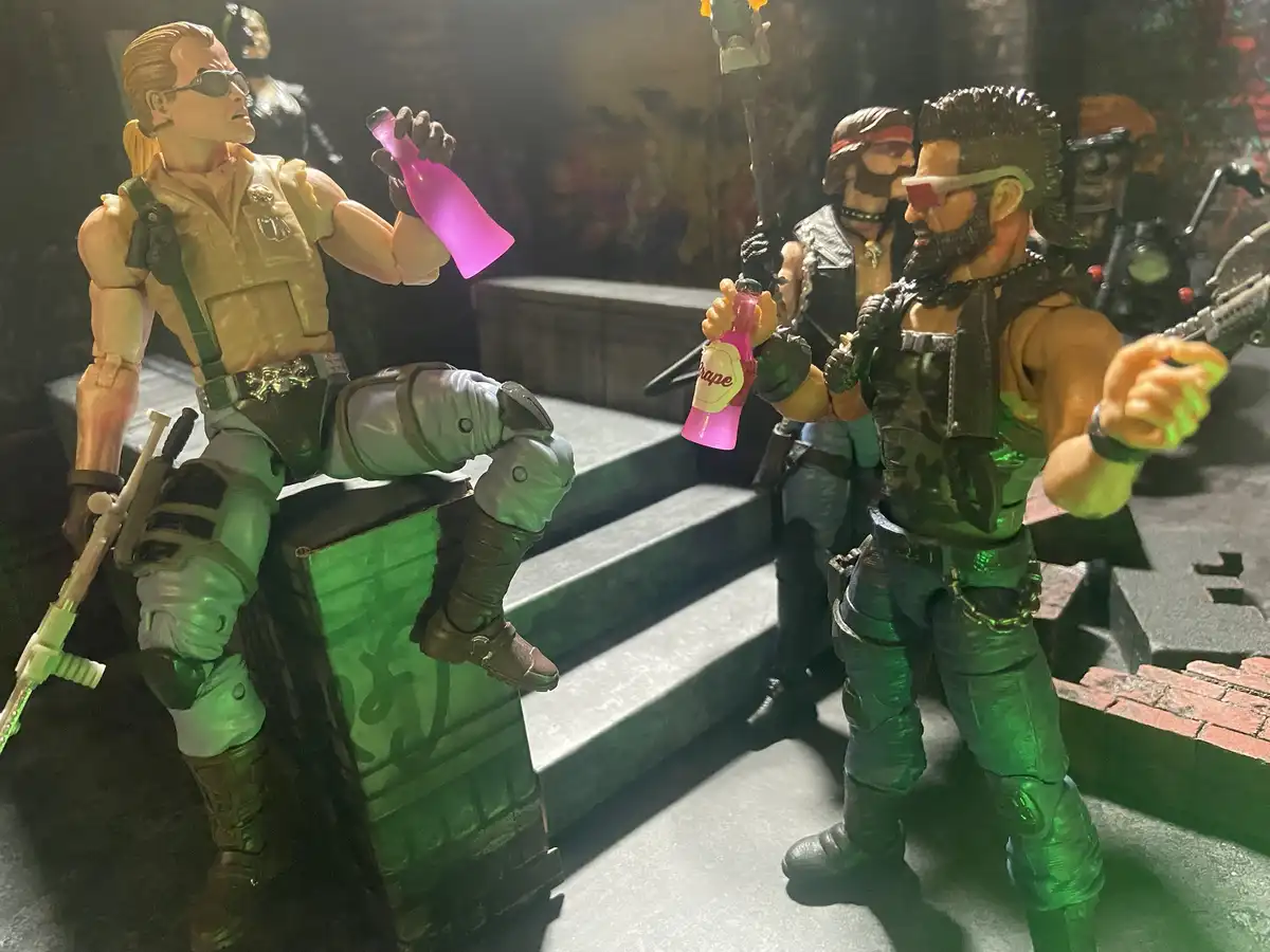 Two action figures resembling characters from the movie 'The Terminator' are shown holding pink grape soda bottles. The…