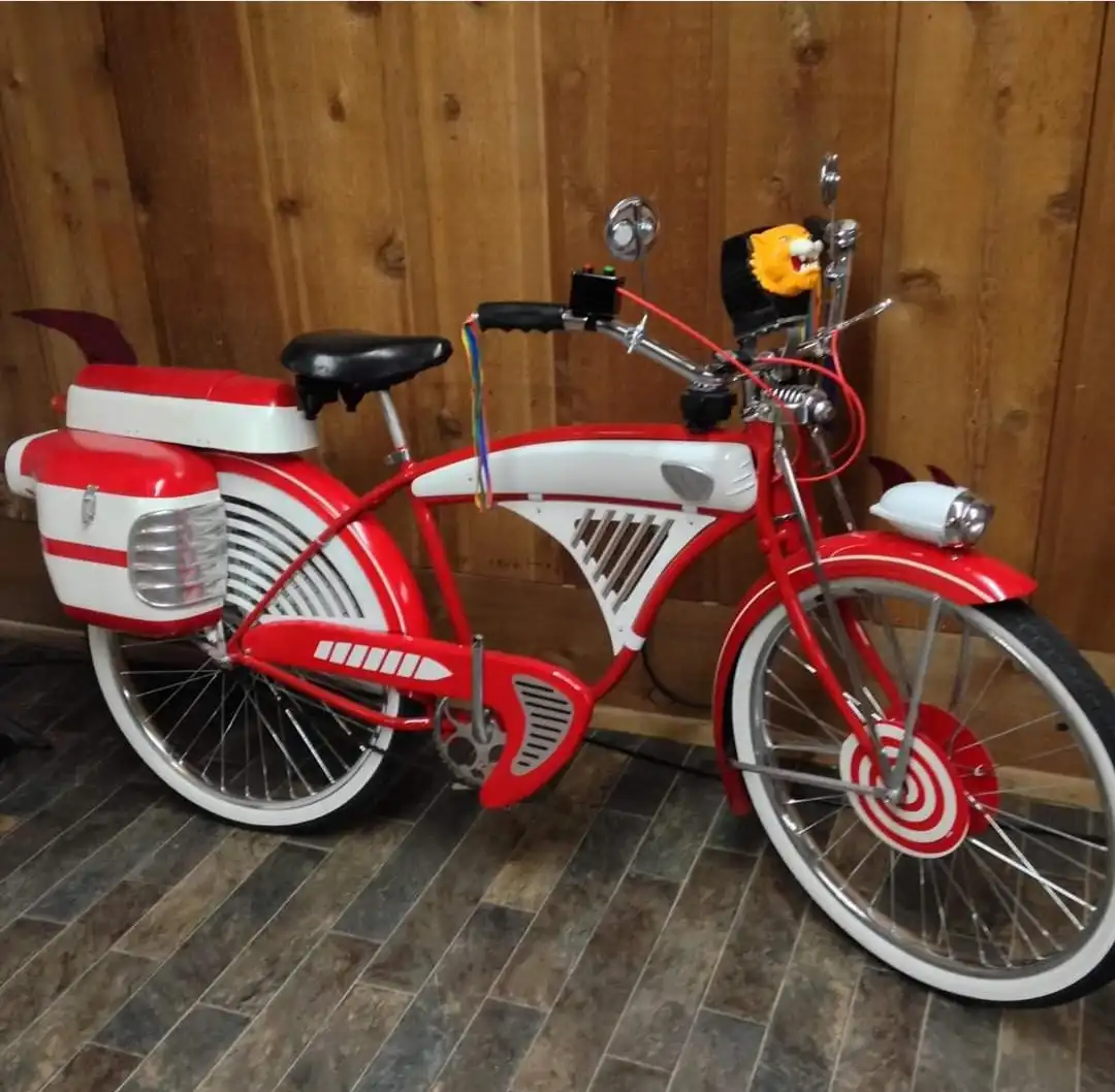 a red and white bicycle with a retro-futuristic design, featuring a lion head mounted on the handlebars, a target painted on…