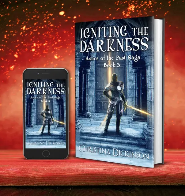 A book cover and a smartphone both display the same fantasy novel titled 'Igniting the Darkness', Book 3 of the 'Ashes of…