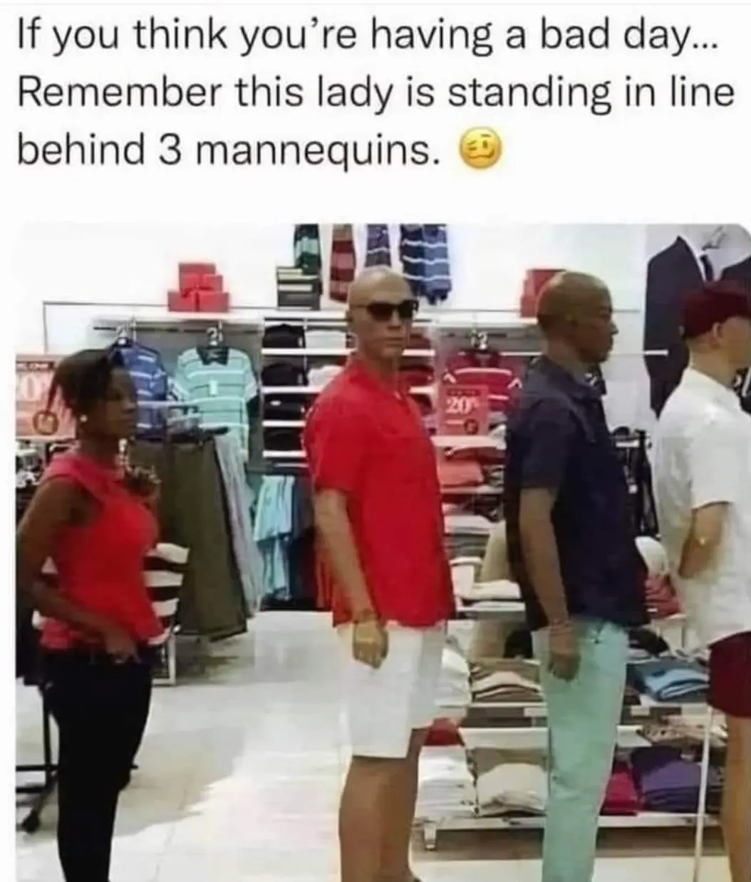A woman in a red top and black pants stands in a clothing store aisle, visibly frustrated, with three mannequins positioned…