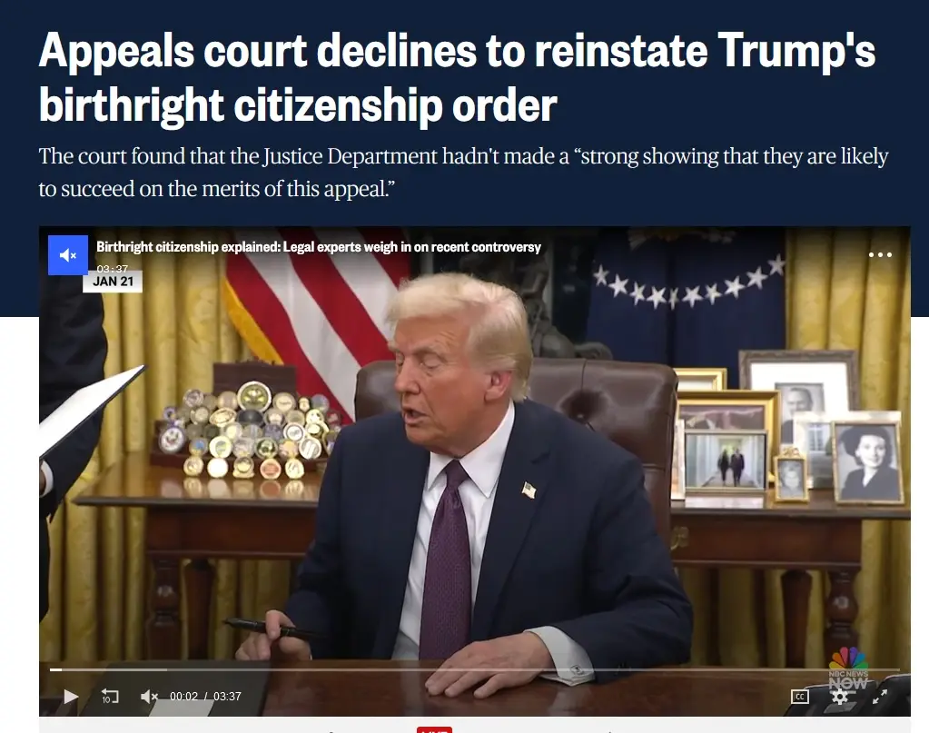 A screenshot of a news video showing Donald Trump seated at a desk in the Oval Office, holding a pen, with an American flag…