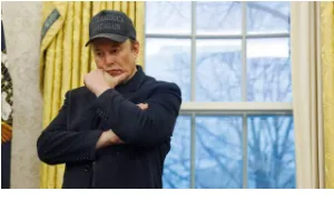 A man, identified as Donald Trump, stands in a room with yellow curtains and a multi-paned window, wearing a dark baseball…