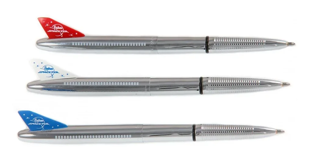 Three silver Fisher Space Pens are shown horizontally against a white background, each with a different colored tail…