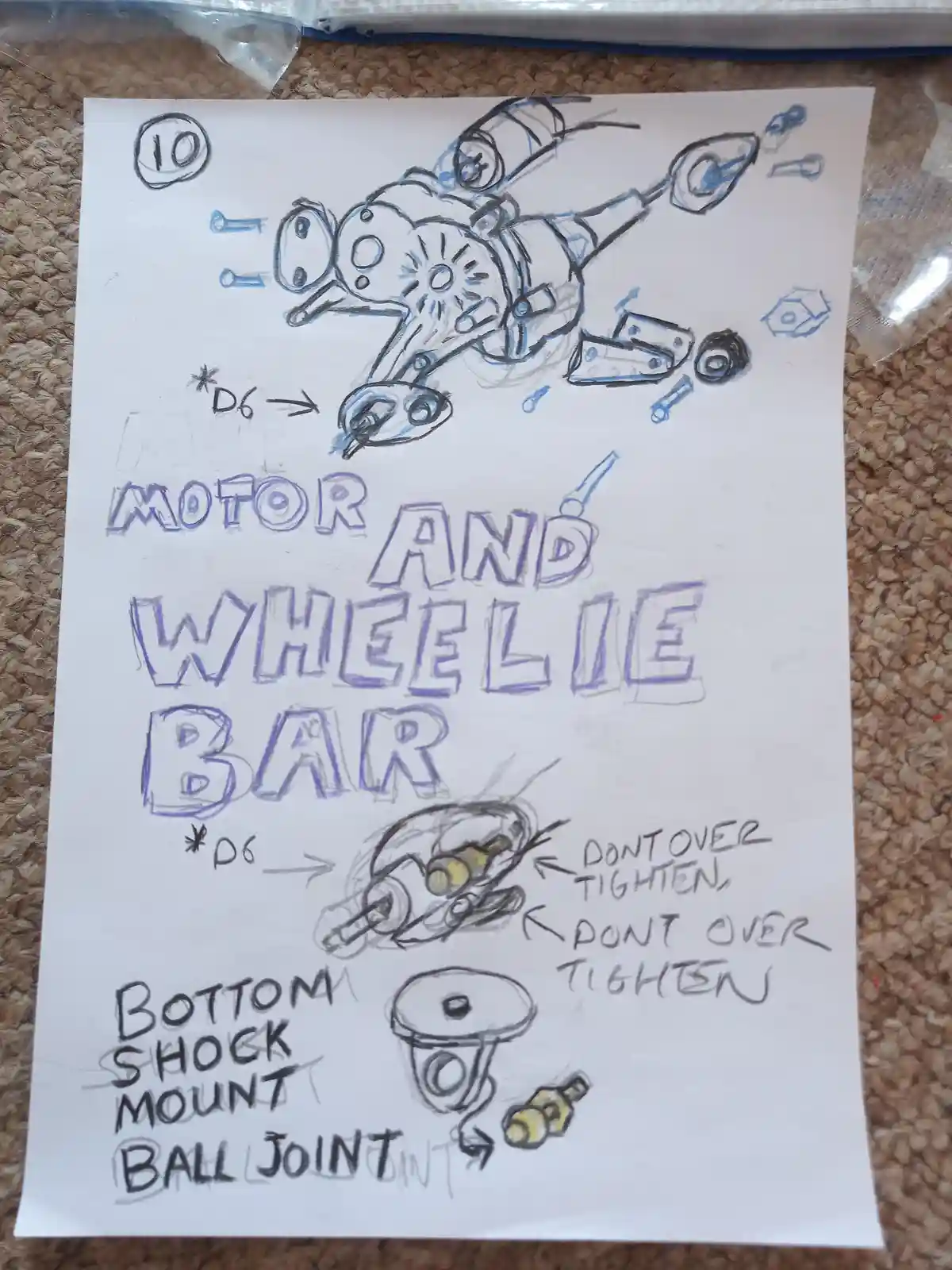 A hand-drawn, blue and black ink diagram on white paper shows mechanical parts labeled 'MOTOR AND WHEELIE BAR', 'BOTTOM…