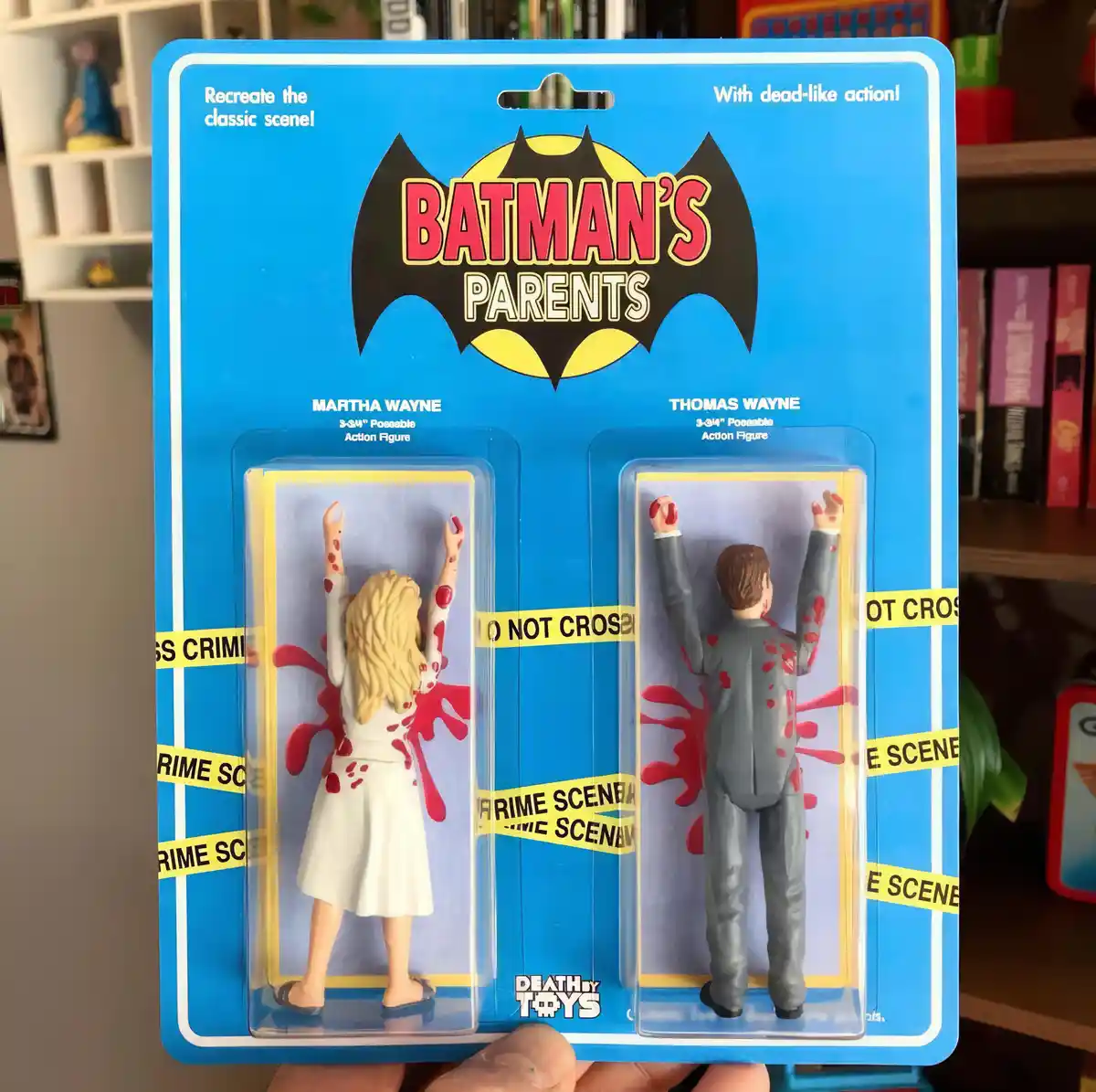 A toy package labeled 'Batman's Parents' displays two action figures of Martha and Thomas Wayne, both shown from behind with…