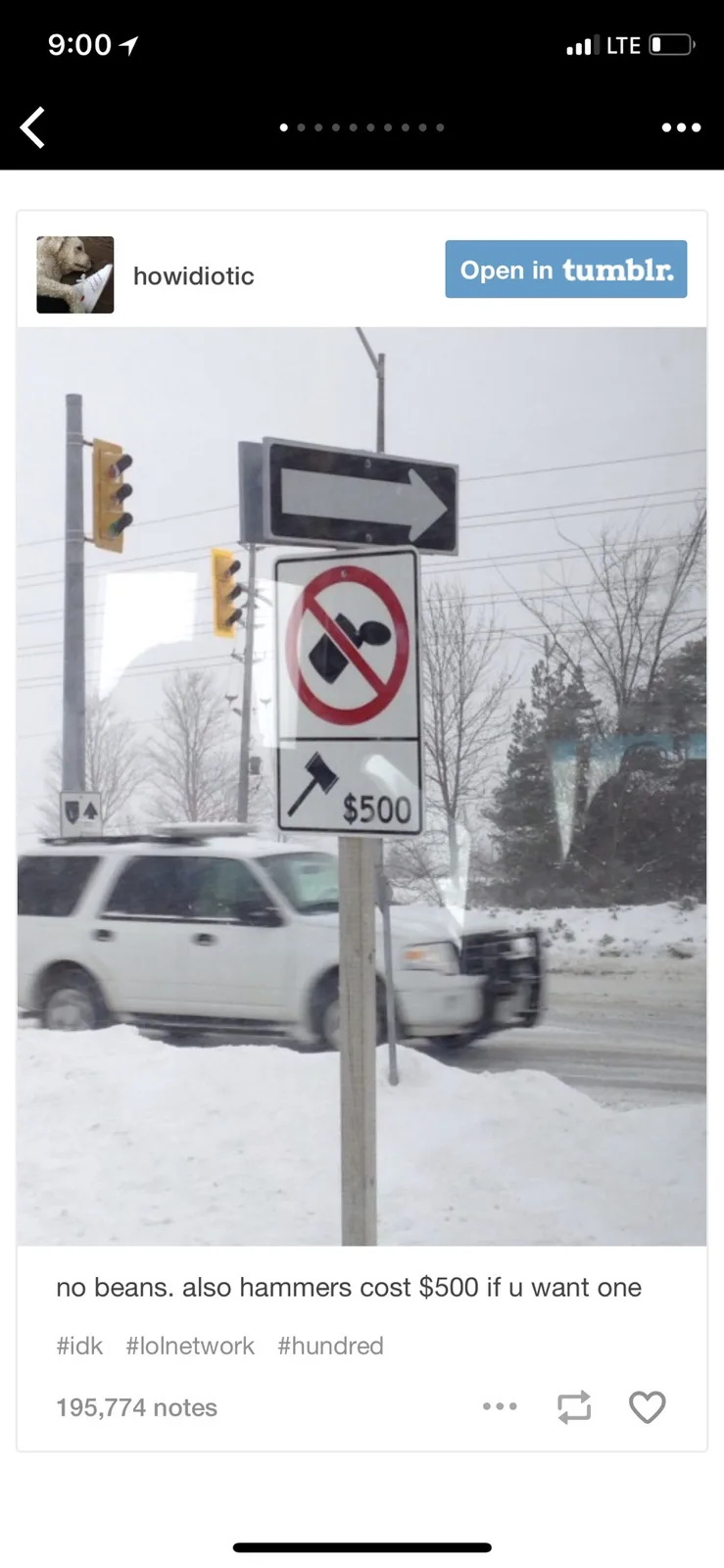 A snowy street scene with a traffic signpost featuring a 'no beans' symbol (a black bean crossed out in red) and a lower…