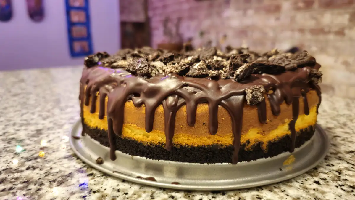 Indulge in Classic Vanilla Cheesecake with Rich Chocolate Ganache