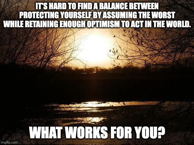 A sunset over a body of water with silhouetted bare tree branches in the foreground. White text at the top reads 'IT'S HARD…