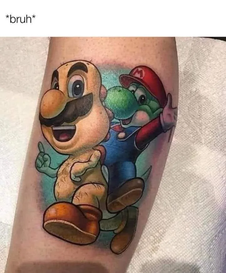 A tattoo on a person's arm depicts a cartoonish, bald, mustachioed character resembling Mario with a green dinosaur-like…