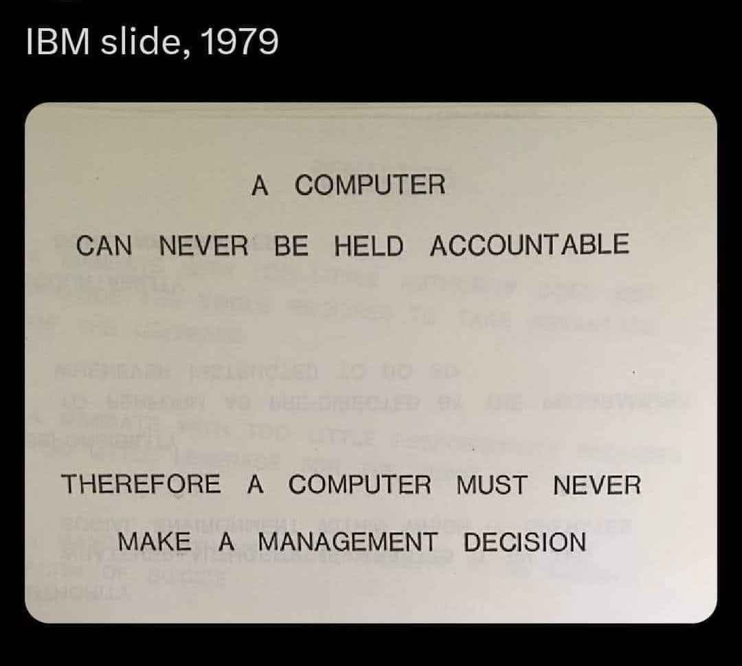 An old IBM presentation slide from 1979 displays a logical argument in bold, uppercase text: 'A COMPUTER CAN NEVER BE HELD…